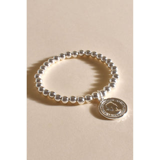 Elevate your style with our Metal-Plated Silver Bracelet featuring delicate round beads and a silver coin charm. Crafted with precision, the bracelet boasts a lustrous metal-plated finish for lasting beauty.