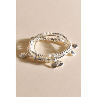 Introducing our Pearl and Silver Stacked Bracelet, a captivating blend of timeless elegance and modern charm. This bracelet features multiple strands adorned with lustrous pearls and sleek silver drops. 