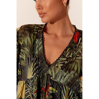 ive headfirst into summer with the Wilma Tropical Dress! Crafted from light linen and covered in a vibrant tropical print, this midi dress has all the makings for a delightful summer outfit for every occasion.