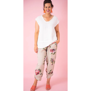 Discover the Penny Floral Pants – where style meets comfort in a captivating dance. Picture yourself in cropped elegance, adorned with a charming cuffed hem and three wood buttons, exuding subtle sophistication with a slight balloon effect. These one-size-fits-all wonders (10-16) are not just pants; they're an invitation to effortless chic.